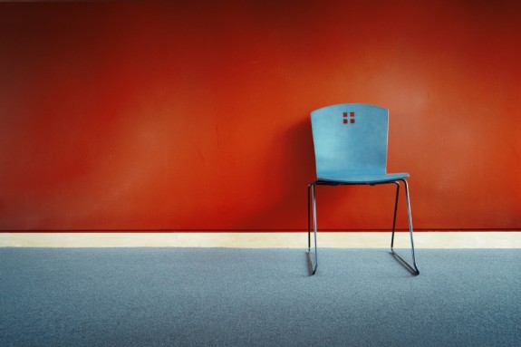 Red chair before blue wall